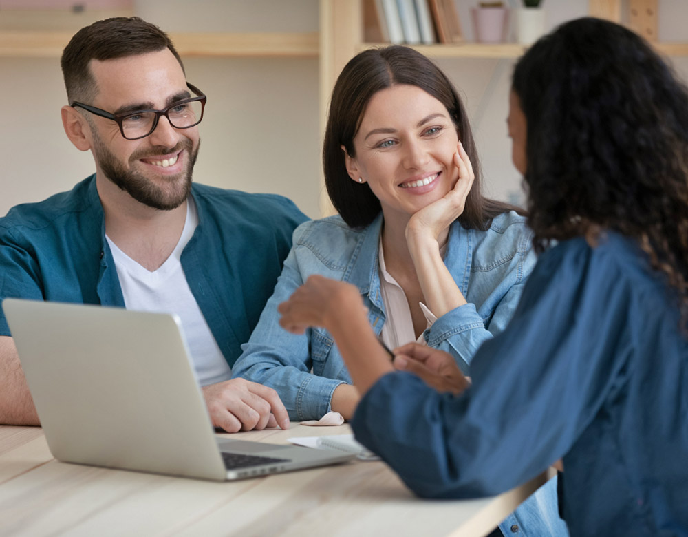 Husband and wife talking with woman about selling land